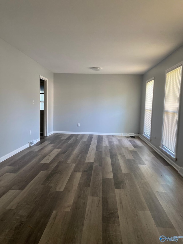 empty room with dark hardwood / wood-style floors