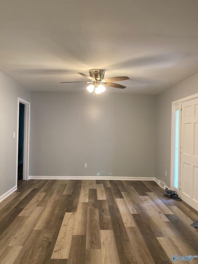 unfurnished room with ceiling fan and dark hardwood / wood-style floors