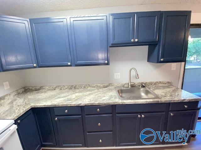 2940 Hood Rd SW Unit I, Huntsville, AL 35805 - kitchen featuring a sink and blue cabinets