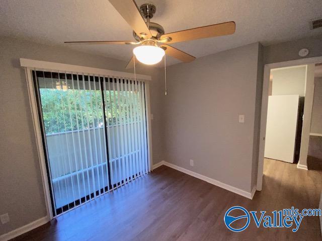 2940 Hood Rd SW Unit I, Huntsville, AL 35805 - empty room with baseboards, a ceiling fan, and wood finished floors