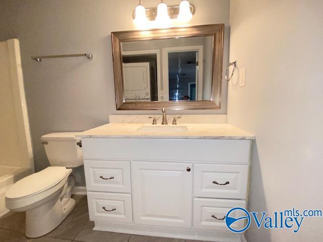 2940 Hood Rd SW Unit I, Huntsville, AL 35805 - bathroom featuring a shower, tile patterned floors, a bathing tub, vanity, and toilet
