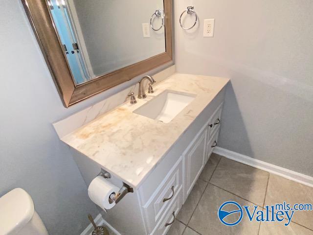2940 Hood Rd SW Unit I, Huntsville, AL 35805 - bathroom with toilet, tile patterned floors, and vanity