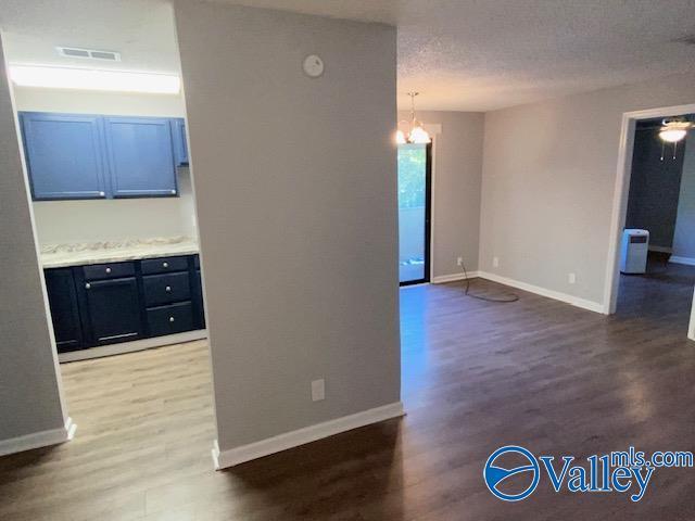 2940 Hood Rd SW Unit I, Huntsville, AL 35805 - interior space with visible vents, wood finished floors, and a chandelier