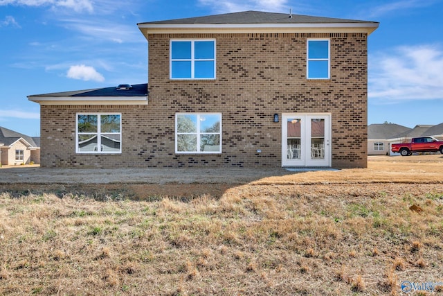 back of house with french doors and brick siding