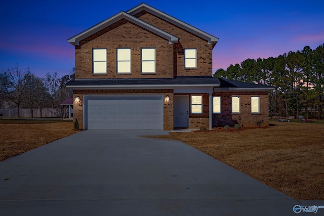 traditional-style home with brick siding, driveway, a front lawn, and a garage