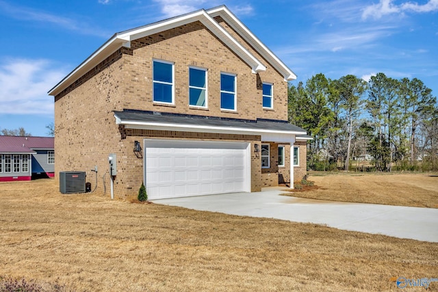 traditional-style house featuring cooling unit, concrete driveway, a front yard, a garage, and brick siding