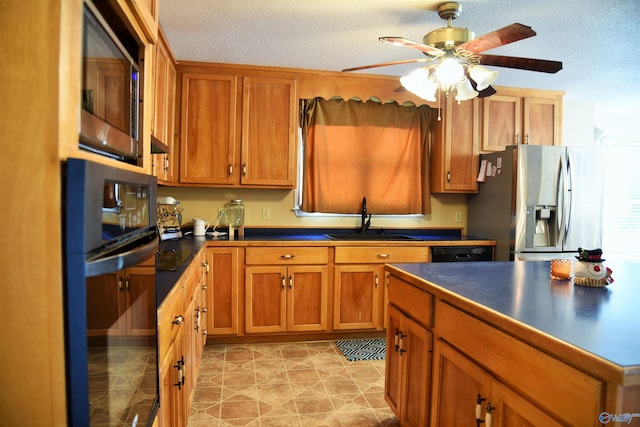 kitchen featuring ceiling fan, sink, a textured ceiling, and black appliances