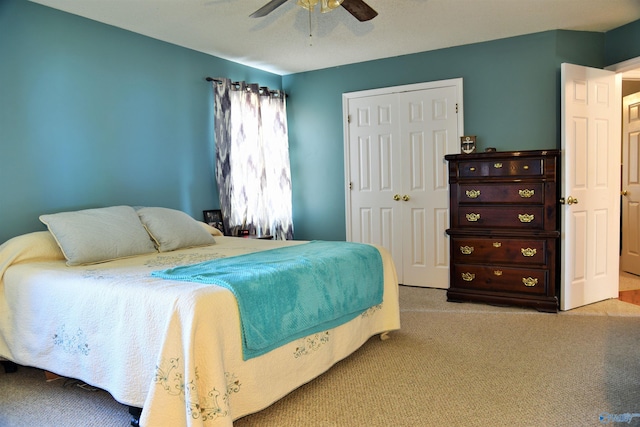 bedroom featuring ceiling fan, light colored carpet, and a closet