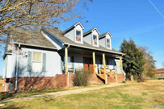 cape cod home featuring a front yard and a porch