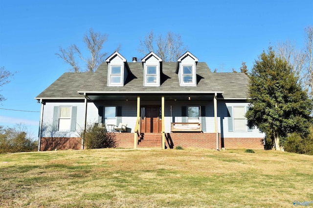 cape cod home with a front yard and a porch