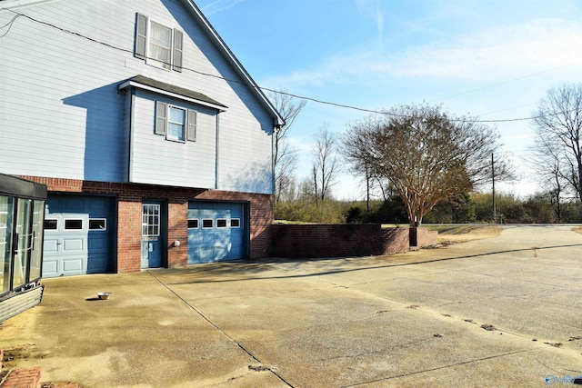 view of side of home featuring a garage