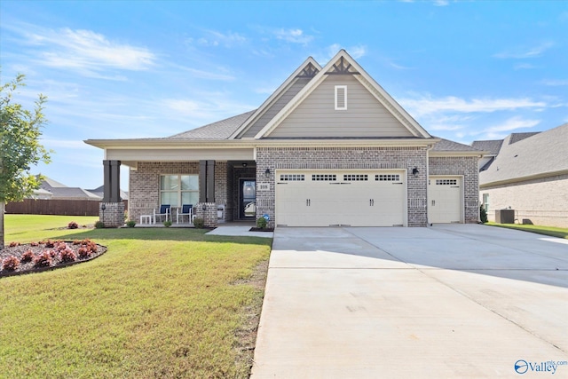 craftsman-style house with a porch, a garage, and a front yard