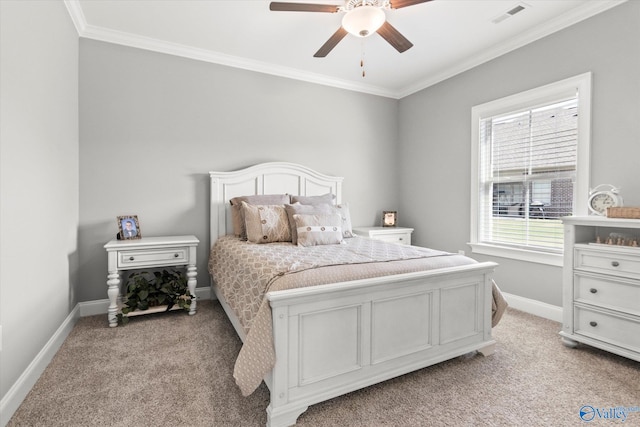 carpeted bedroom with ceiling fan and ornamental molding