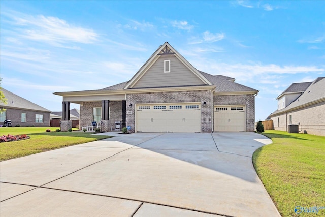 craftsman-style house with a garage, a front lawn, and central air condition unit