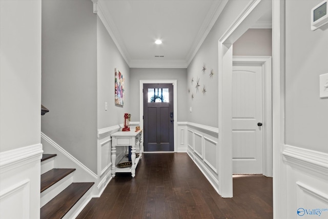 foyer featuring dark hardwood / wood-style floors and ornamental molding