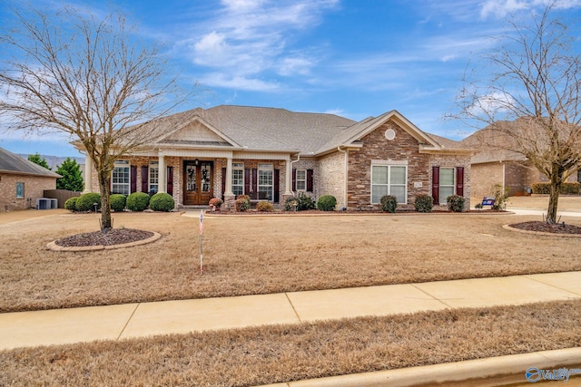 view of front of property with a shingled roof and brick siding