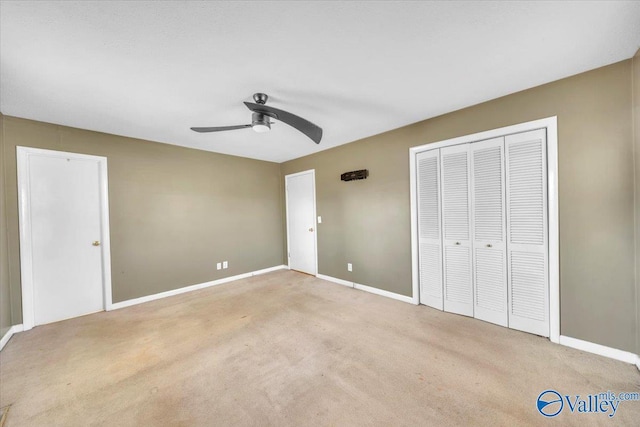 unfurnished bedroom featuring a closet, carpet flooring, ceiling fan, and baseboards