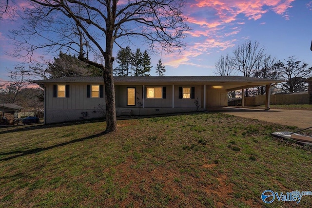 single story home with a lawn, driveway, board and batten siding, crawl space, and a carport