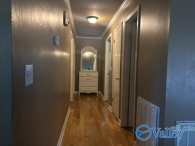 hall with crown molding and dark hardwood / wood-style floors