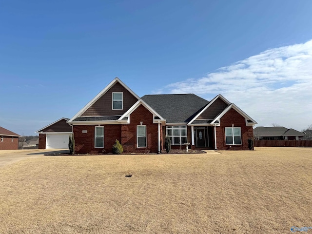 craftsman-style house featuring a garage and a front yard