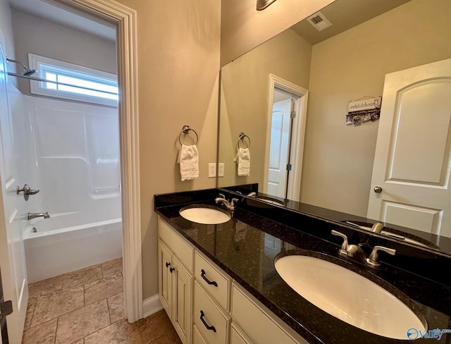 bathroom with vanity and shower / washtub combination