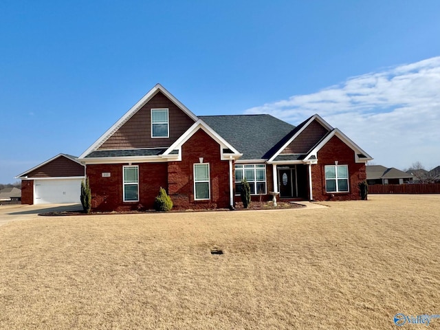 craftsman-style house with a garage and a front lawn