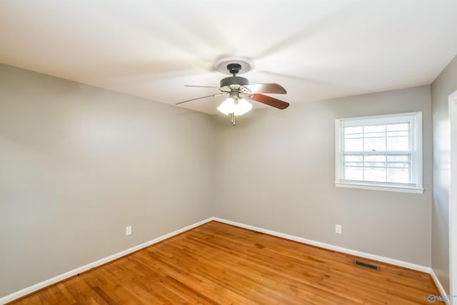 spare room with light wood-type flooring and ceiling fan