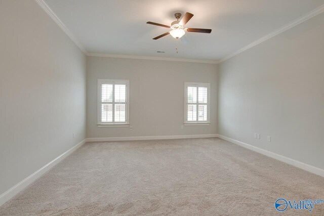 carpeted empty room with ceiling fan and ornamental molding