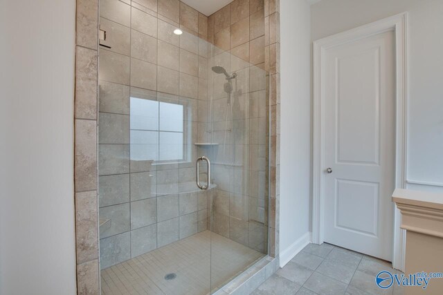 bathroom with tile patterned flooring and walk in shower