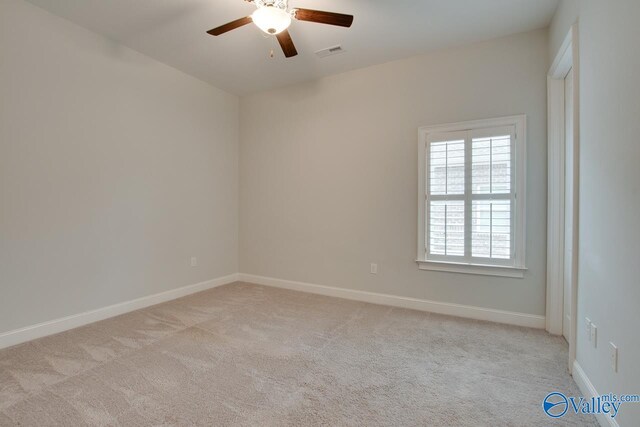 unfurnished room featuring ceiling fan and light colored carpet