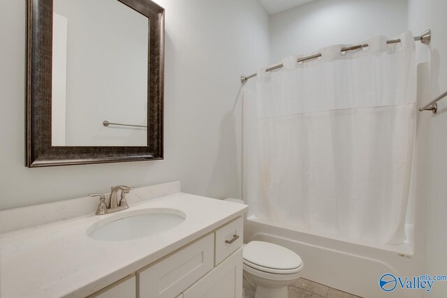 full bathroom with tile patterned floors, vanity, toilet, and shower / tub combo with curtain