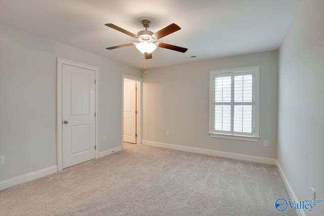 carpeted empty room with ceiling fan