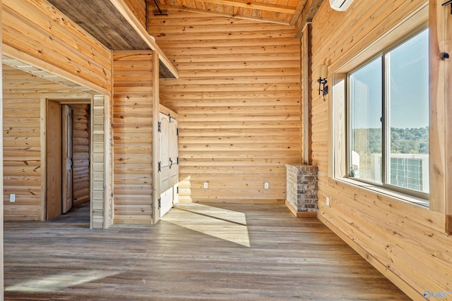 unfurnished room with wooden walls, hardwood / wood-style floors, and lofted ceiling