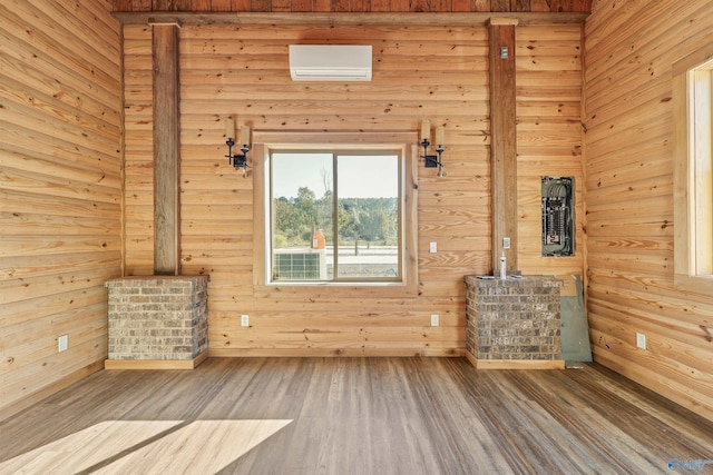 unfurnished living room featuring wooden walls and hardwood / wood-style flooring