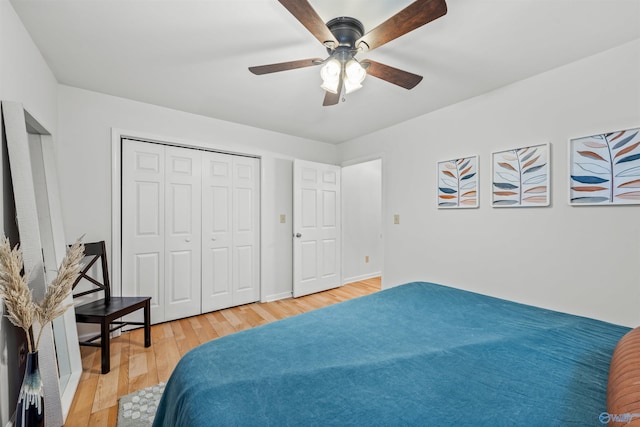 bedroom featuring light wood-type flooring, a closet, and ceiling fan