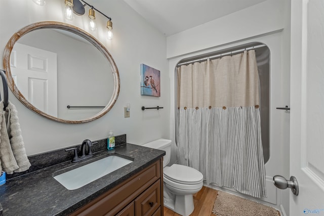 bathroom with toilet, vanity, hardwood / wood-style floors, and a shower with shower curtain