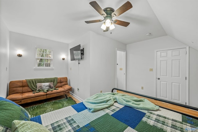 bedroom with hardwood / wood-style flooring, ceiling fan, and vaulted ceiling