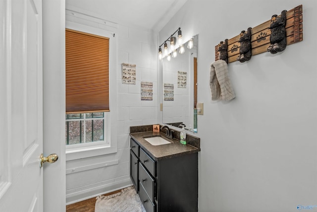 bathroom featuring tile walls and vanity