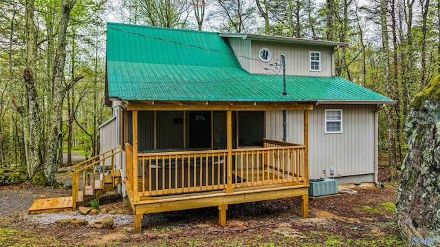 back of house featuring central air condition unit and a deck