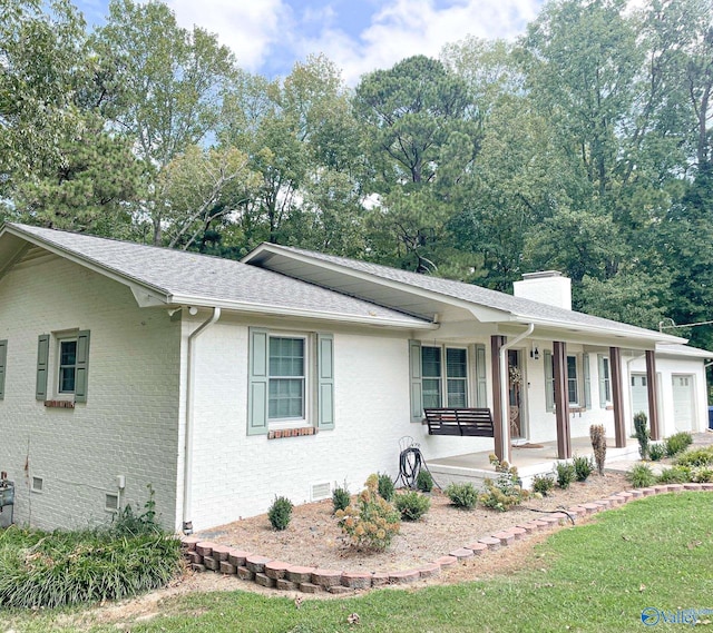 single story home with a porch and a garage