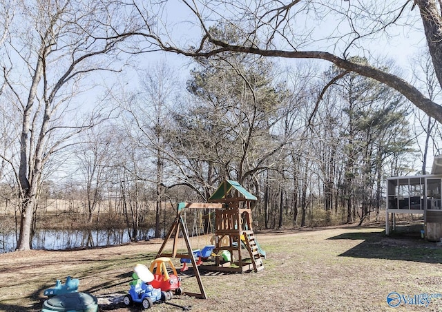 view of play area with a water view and a sunroom