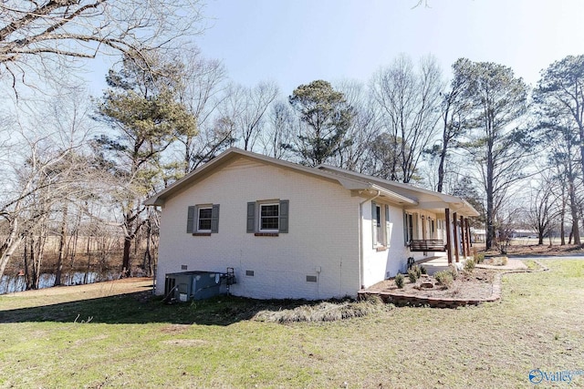 view of home's exterior with a yard, central AC unit, and covered porch