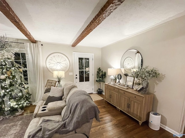 living area featuring beam ceiling, a textured ceiling, and dark hardwood / wood-style floors