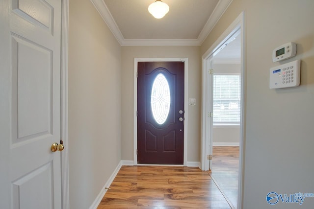 entryway featuring light wood-style flooring, crown molding, and baseboards