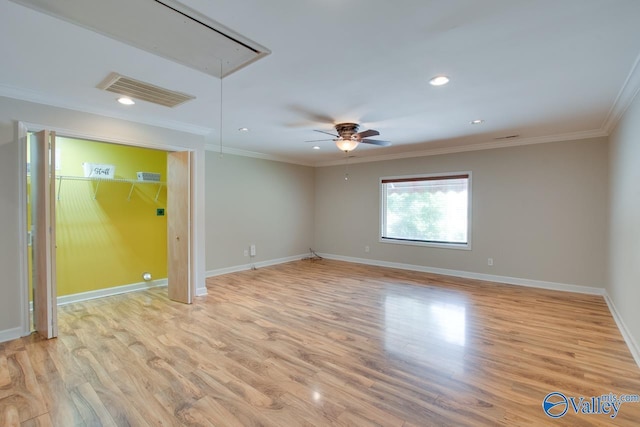 empty room featuring attic access, ornamental molding, light wood finished floors, baseboards, and recessed lighting