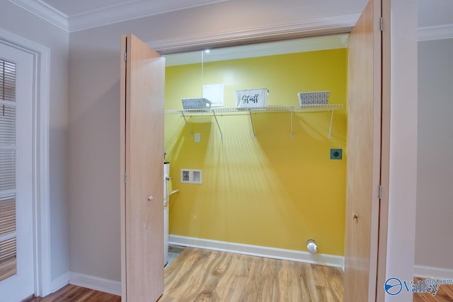laundry area with hookup for a washing machine, electric dryer hookup, crown molding, wood finished floors, and baseboards