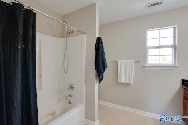 full bath featuring shower / tub combo, baseboards, and vanity