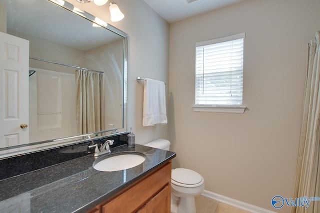 bathroom featuring toilet, tile patterned flooring, vanity, curtained shower, and baseboards