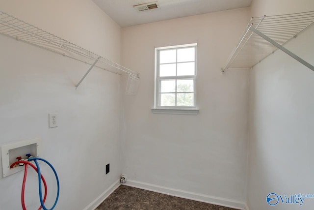 laundry room with hookup for a washing machine and baseboards