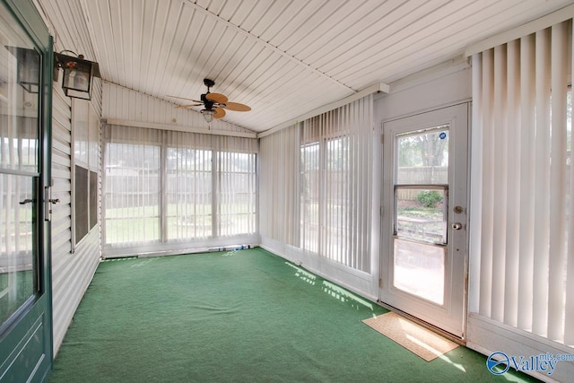 unfurnished sunroom featuring ceiling fan and vaulted ceiling